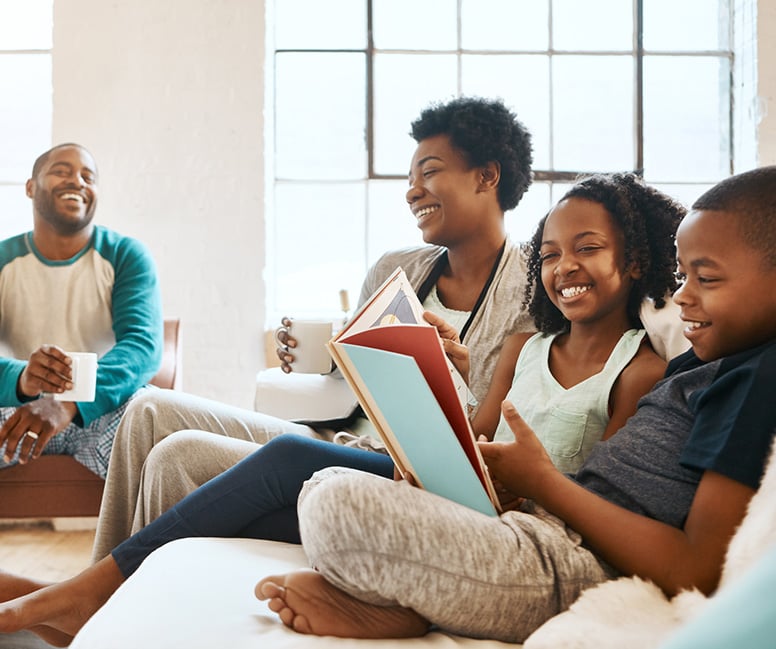 Family reading together in living room.