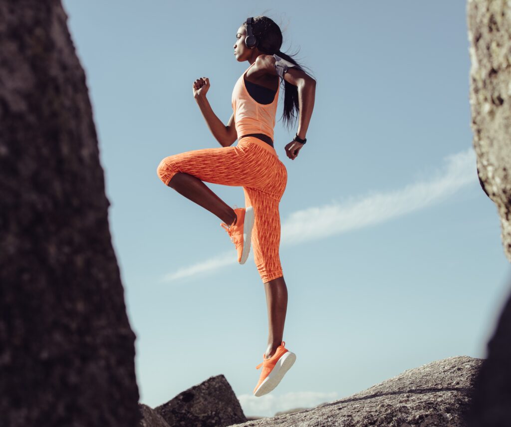 Woman leaping while exercising.